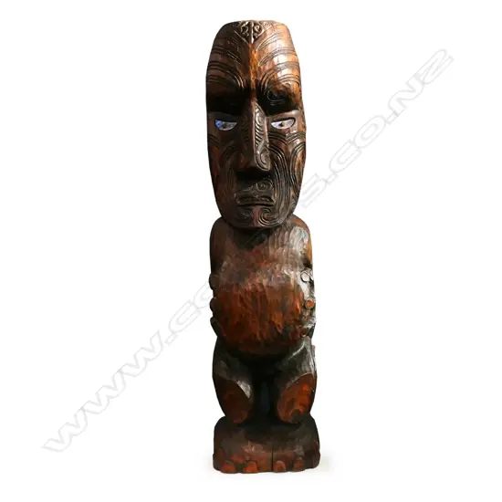 A large Māori carved tekoteko stylised figure,